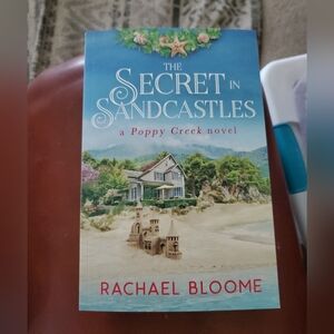 Secret in Sandcastles: A Poppy Creek Novel by Rachael Bloome. Used condition.